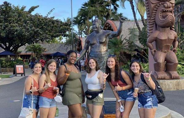 Students stand in front of the Polynesian Cultural Center